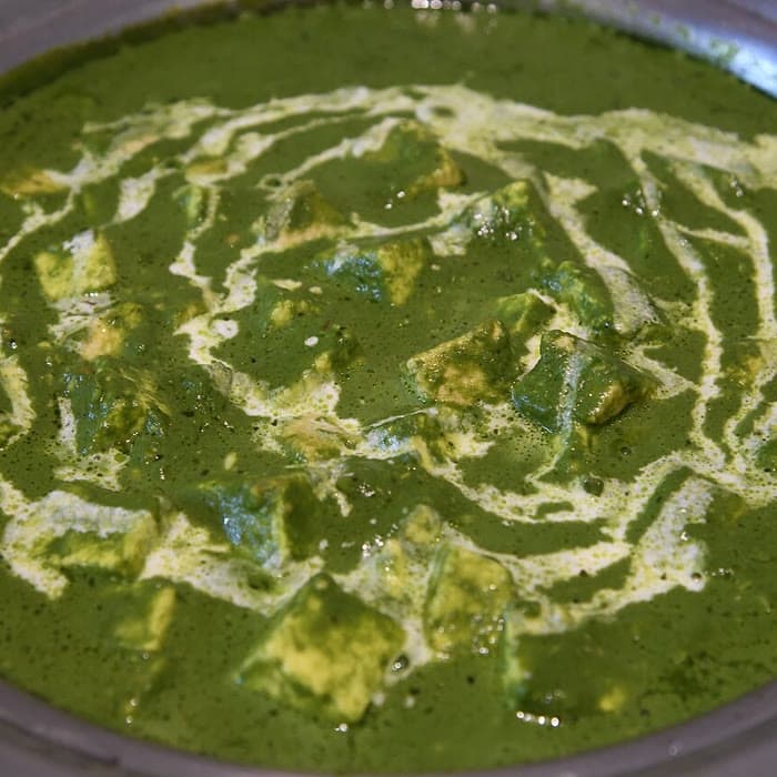 Palak paneer with a swirl of cream